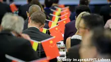 Chinese and German businessmen attend the 3rd Oak Garden Business forum on the Environmental Campus Birkenfeld in Hoppenstaedten-Weiersbach, western Germany on September 7, 2018. - For just over a million yuan each (125,000 euros), 12 Chinese businessmen were promised apartments in the so-called Oak Garden residential complex, a former housing of the US Army in the German western town of Hoppstaedten-Weiersbach, and help with navigating Germany's bureaucracy including obtaining residency permits and registering a business. All of them had been won over by Chinese businesswoman Jane Hou and her German partner Andreas Scholz, who conceived the idea of building the biggest Chinese trading centre in Europe. (Photo by Thomas Lohnes / AFP) (Photo credit should read THOMAS LOHNES/AFP via Getty Images)