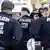 Police officers seen from behind / Geisler-Fotopress/C. Hardt)