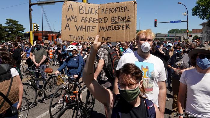 Demonstrators protest the killing of George Floyd outside of the city's 5th police precinct