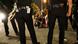 Police in LA surround two people sitting on the ground Police in LA surround two people sitting on the ground