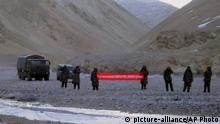 FILE- In this May 5, 2013 file photo, Chinese troop hold a banner which reads, You've crossed the border, please go back, in Ladakh, India. Chinese President Xi Jinping is coming to India to meet with Prime Minister Narendra Modi on Friday, Oct. 11, 2019, just weeks after Beijing supported India's rival Pakistan in raising the issue of New Delhi's recent actions in disputed Kashmir at the U.N. General Assembly meeting. The countries fought a brief but bloody border war in 1962 over their disputed frontier and their armed forces engaged in a 10-week standoff in the neighboring state of Bhutan in 2017. (AP Photo, file) |