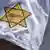 Yellow star on sleeve with "not vaccinated" written on it