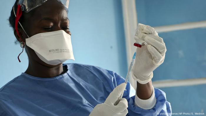 A health worker holding a needle