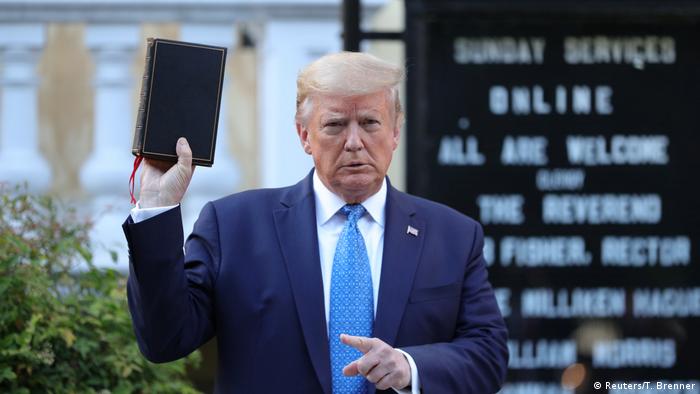 Trump holds a Bible up outside a church by the White House (Reuters/T. Brenner)
