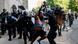 Riot police chase a man as they rush protestors to clear Lafayette Park Riot police chase a man as they rush protestors to clear Lafayette Park