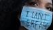 A woman in a surgical mask with the words "I can't breathe" A woman in a surgical mask with the words "I can't breathe"