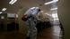 A quarantine worker sprays disinfectant at a high school A quarantine worker sprays disinfectant at a high school