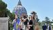 Visitors at the gardens in the background the dome of the Basilica of St. Peter Visitors at the gardens in the background the dome of the Basilica of St. Peter