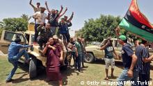 June 5, 2020***
Fighters loyal to Libya's UN-recognised Government of National Accord (GNA), pose for a group picture as they celebrate in the town of Tarhouna, about 65 kilometres southeast of the capital Tripoli on June 5, 2020, after the area was taken over by pro-GNA forces following clashes with rival forces loyal to strongman Khalifa Haftar. - The GNA said on June 5 that it was back in full control of Tarhouna, the last stronghold of the forces of eastern strongman Khalifa Haftar. The UN-recognised government had announced the day before that they were also in full control of the capital Tripoli and its surroundings. (Photo by Mahmud TURKIA / AFP) (Photo by MAHMUD TURKIA/AFP via Getty Images)