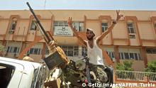 June 5, 2020***
A fighter loyal to Libya's UN-recognised Government of National Accord (GNA) poses for a picture while seated in the turret a technical (pickup truck mounted with turret) in the town of Tarhouna, about 65 kilometres southeast of the capital Tripoli on June 5, 2020, after the area was taken over by pro-GNA forces following clashes with rival forces loyal to strongman Khalifa Haftar. - The GNA said on June 5 that it was back in full control of Tarhouna, the last stronghold of the forces of eastern strongman Khalifa Haftar. The UN-recognised government had announced the day before that they were also in full control of the capital Tripoli and its surroundings. (Photo by Mahmud TURKIA / AFP) (Photo by MAHMUD TURKIA/AFP via Getty Images)