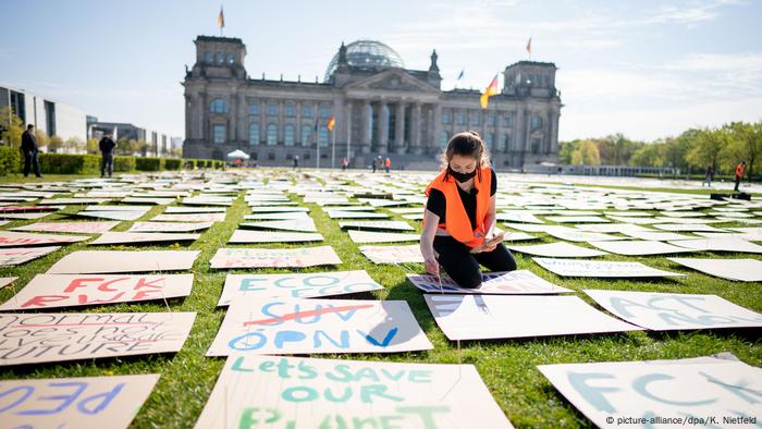 Luisa Neubauer of Fridays for Future sets up protest signs in front of the German parliament