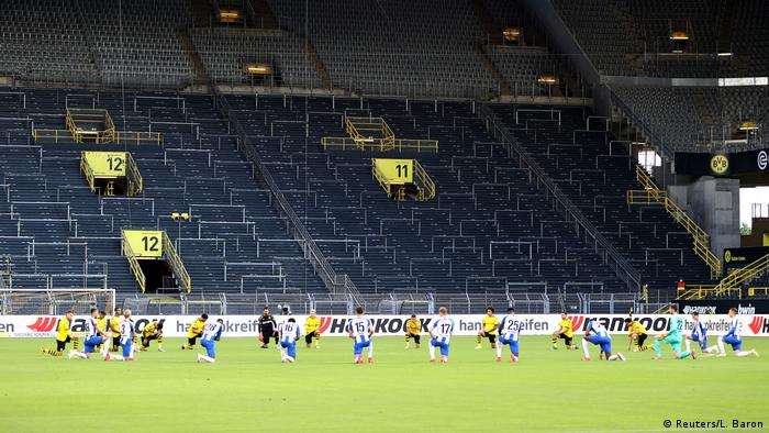 Before Dortmund's game against Hertha, both teams knelt around the center circle