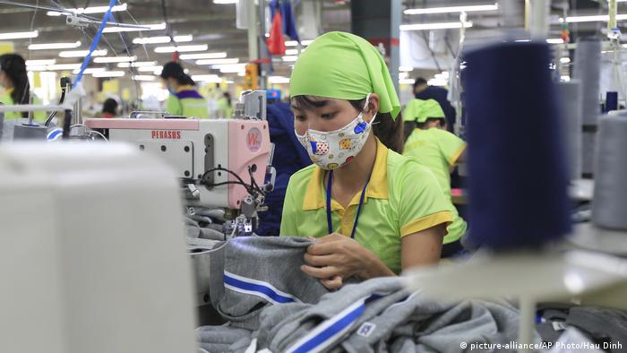 A worker sews a garment at Pro Sports factory in Nam Dinh province