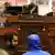 Syrian army defector "Caesar" in a blue jacket briefs the House Committee on Foreign Affairs