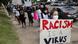 Angela Truex, of Jackson, Miss., carries a sign describing racism as a virus, during a march Angela Truex, of Jackson, Miss., carries a sign describing racism as a virus, during a march