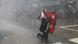 A Nepalese youth holding the national flag of Nepal braves the water cannon during a protest near the Prime Minister's official residence, demanding better and effective response from the government to fight the coronavirus disease A Nepalese youth holding the national flag of Nepal braves the water cannon during a protest near the Prime Minister's official residence, demanding better and effective response from the government to fight the coronavirus disease