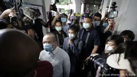 Rappler CEO and Executive Editor Maria Ressa, center, is escorted as she arrives to attend a court hearing for a cyber libel case at Manila Regional Trial Court, Philippines