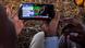 Two people watch a speech by Tanzania's President John Magufuli on a smartphone Two people watch a speech by Tanzania's President John Magufuli on a smartphone