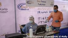 A health worker wearing protective gear prepares to take swab samples from people queuing in their cars to test for the coronavirus at a drive-through COVID-19 screening center at Ain Shams University in Cairo, Egypt, Wednesday, June 17, 2020. (AP Photo/Nariman El-Mofty) |