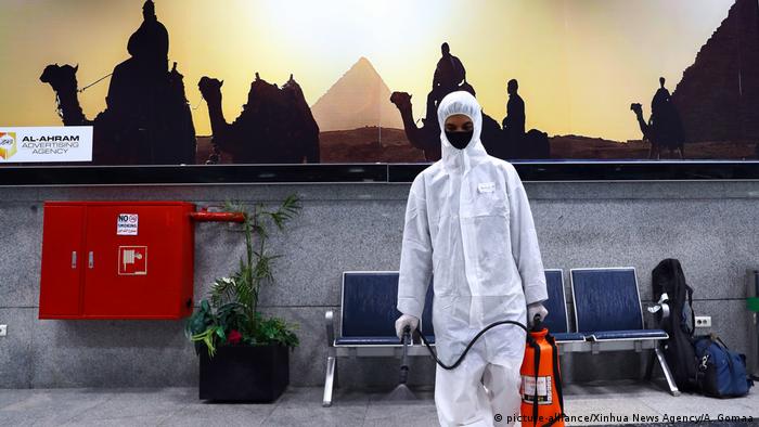 A worker sprays disinfectant at Hurghada International Airport