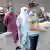 Health workers checks people's body temperature in Lahore city