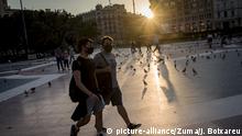 June 20, 2020, Barcelona, Catalonia, Spain: Two young men wearing face masks walk down Barcelona's Catalunya square at sunset. On Sunday June 21, Spain will enter the 'new normality' and, after three months, the state of alarm will come to the end. (Credit Image: Â© Jordi Boixareu/ZUMA Wire |