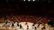 Musicians spread out on the semicircular stage, conductor with arm raised at center, small clusters in the mostly unoccupied seats in front of them in the Cologne Philharmonie Musicians spread out on the semicircular stage, conductor with arm raised at center, small clusters in the mostly unoccupied seats in front of them in the Cologne Philharmonie