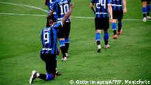 Inter Milan's Belgian forward Romelu Lukaku kneels on the pitch after opening the scoring during the Italian Serie A football match Inter vs Sampdoria, played on June 21, 2020 at the Giuseppe Meazza stadium in Milan, behind closed doors as the country gradually eases its lockdown aimed at curbing the spread of the COVID-19 infection, caused by the novel coronavirus. (Photo by Filippo MONTEFORTE / AFP) (Photo by FILIPPO MONTEFORTE/AFP via Getty Images)