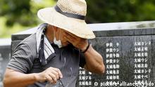 A man cries before the Cornerstone of Peace at the Peace Memorial Park in Itoman, Okinawa Prefecture, on June 23, 2020, the 75th anniversary of the end of a major World War II ground battle in Okinawa that claimed over 200,000 lives, including large numbers of local civilians as well as Japanese and U.S. combatants. (Kyodo) |