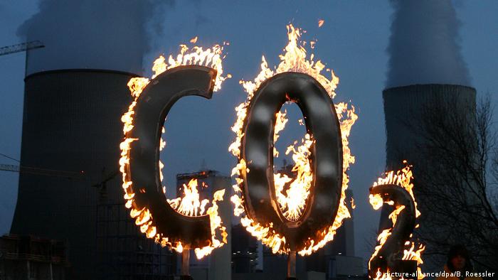 Burning CO2 sign set up by Greenpeace in front of a power plant in Germany