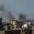 Дым на фоне зданий в столице Ливии Триполи, апрель 2020 года