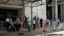 18.06.2020 *** People wait for health assessment check-in before entering Jackson Memorial Hospital, as Miami-Dade County eases some of the lockdown measures put in place during the coronavirus disease (COVID-19) outbreak, in Miami, Florida, U.S., June 18, 2020. REUTERS/Marco Bello
