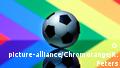 A football against the backdrop of a rainbow flag