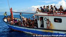 Rohingya refugees are seen on a boat while being rescued by fishermen near the coast of Seunuddon beach in Aceh, Indonesia, June 24, 2020. Antara Foto/Rahmad/via REUTERS ATTENTION EDITORS - THIS IMAGE HAS BEEN SUPPLIED BY A THIRD PARTY. MANDATORY CREDIT. INDONESIA OUT. NO COMMERCIAL OR EDITORIAL SALES IN INDONESIA.