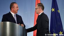 German Foreign Minister Heiko Maas and Turkish Foreign Minister Mevlut Cavusoglu talk after addressing the media during a joint news conference after a meeting in Berlin, Germany July 2, 2020. Michael Sohn/Pool via REUTERS