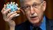 Francis Collins holds up a model of the coronavirus during a Senate subcommittee hearing Francis Collins holds up a model of the coronavirus during a Senate subcommittee hearing