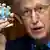 Francis Collins holds up a model of the coronavirus during a Senate subcommittee hearing