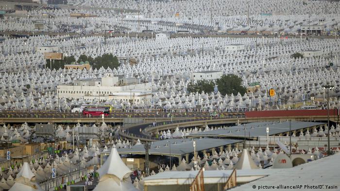 Muslim pilgrims walk back to their tents during the annual Haj pilgrimage on the first day of Eid al-Adha in Mina