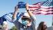 A trump supporter in a mask holds up a sign at a Mount Rushmore rally A trump supporter in a mask holds up a sign at a Mount Rushmore rally