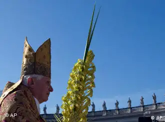 Pope Benedict XVI holds a woven palm frond while celebrating an open-air Palm Sunday mass in St. Peter's square at the Vatican, Sunday, March 28, 2010