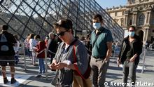 Visitors queue in front of the Louvre Pyramid designed by Chinese-born U.S. architect Ieoh Ming Pei in Paris as the museum reopens its doors to the public after almost 4-month closure due to the coronavirus disease (COVID-19) outbreak in France, July 6, 2020. REUTERS/Charles Platiau