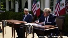 Mexican President Andres Manuel Lopez Obrador looks on as President Donald Trump signs a joint declaration at the White House, Wednesday, July 8, 2020, in Washington. (AP Photo/Evan Vucci) |
