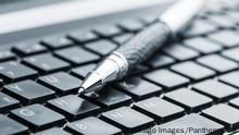 Pen on the keyboard Copyright: xNomadSoulx Panthermedia28084865