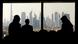 Three people in a building with Dubai skyscrapers in the background Three people in a building with Dubai skyscrapers in the background
