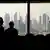 Three people in a building with Dubai skyscrapers in the background