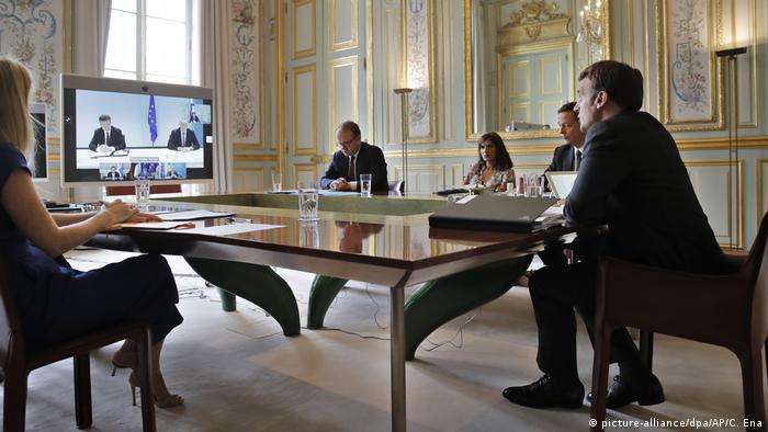 French President Emmanuel Macron and colleagues take part in the video conference.