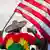 A man wearing a pullover in Ethiopia's colors holds up the US flag in protests from July 8, 2020