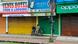 A policeman sits on a parked motorcycle in front of closed shops after a new lockdown was imposed as a preventive measure against the spread of the COVID-19 coronavirus, in Siliguri on July 17, 2020 A policeman sits on a parked motorcycle in front of closed shops after a new lockdown was imposed as a preventive measure against the spread of the COVID-19 coronavirus, in Siliguri on July 17, 2020