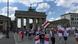 Demonstrators wave Belarus flags and placards walking past Berlin's Brandenburg Gate. Archive image from July 2020. Demonstrators wave Belarus flags and placards walking past Berlin's Brandenburg Gate. Archive image from July 2020.
