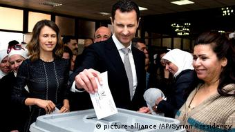 Syrian President Bashar Assad casting his ballot in the parliamentary elections in 2016, next to him his wife Asma.